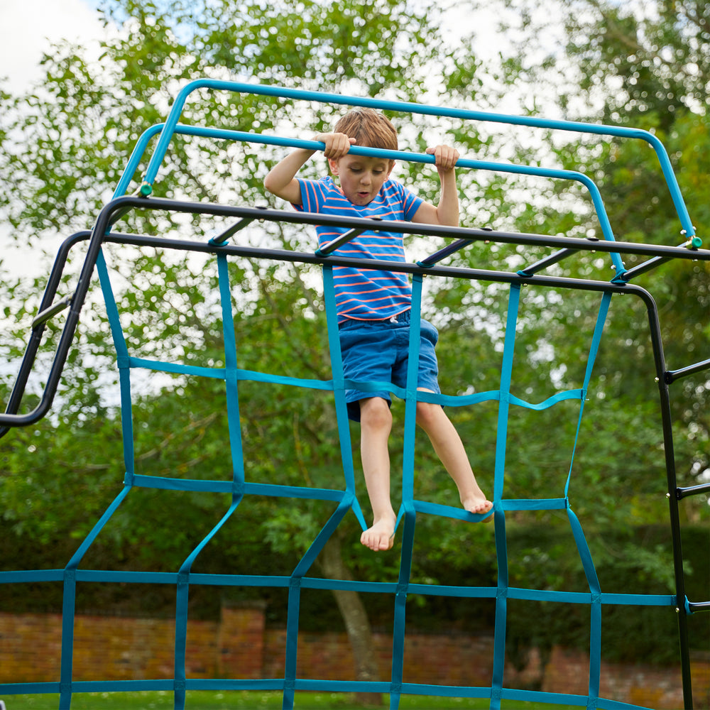  Child climbing on metal climbing frame 