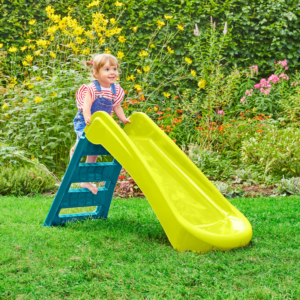 Child playing on plastic folding garden slide