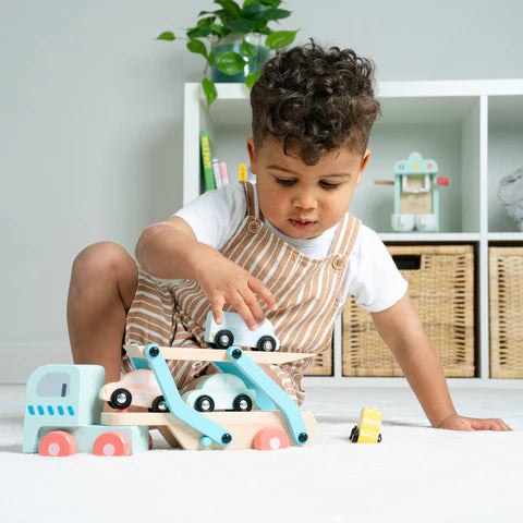 Child playing with wooden cars