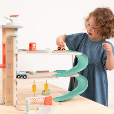  Child playing with wooden car garage 