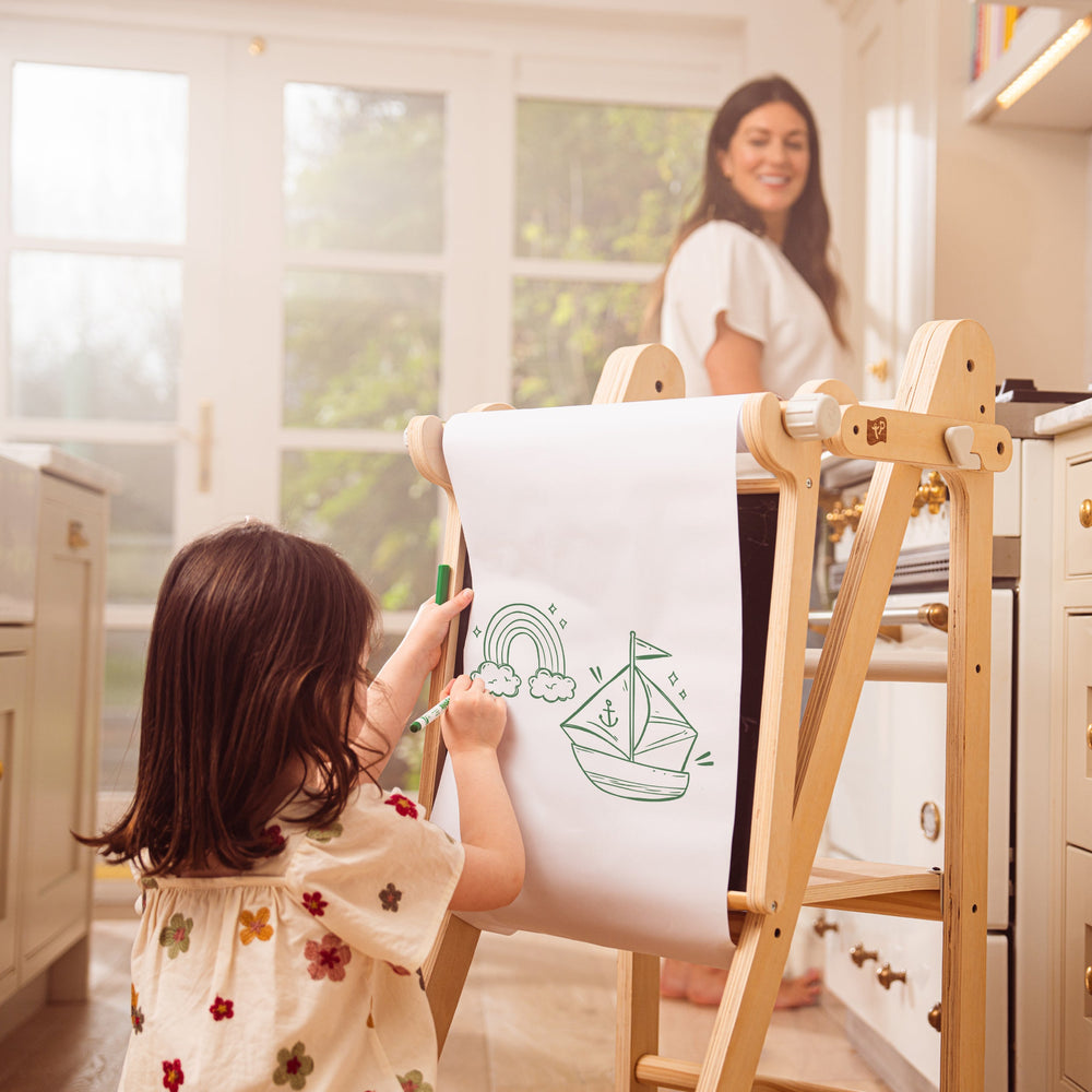 Child playing with wooden easel art set