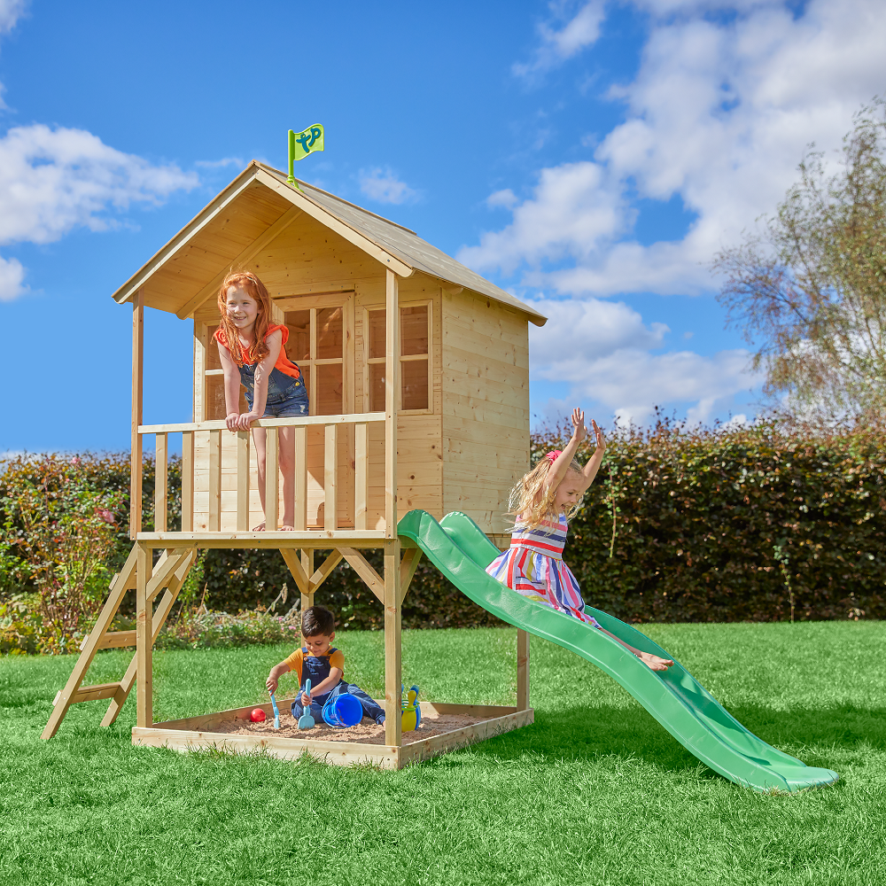  Children playing on a two storey playhouse with slide 