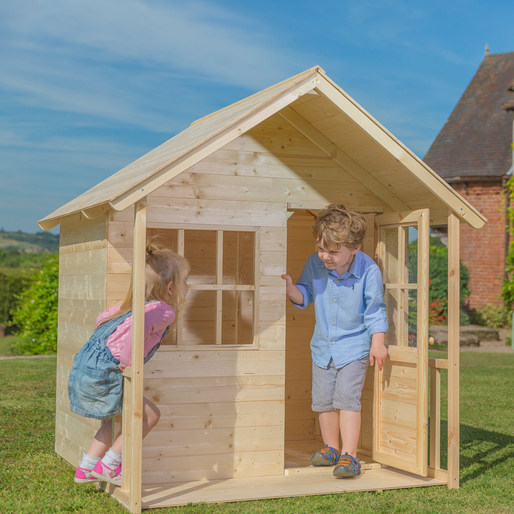 Children playing in wooden playhouse