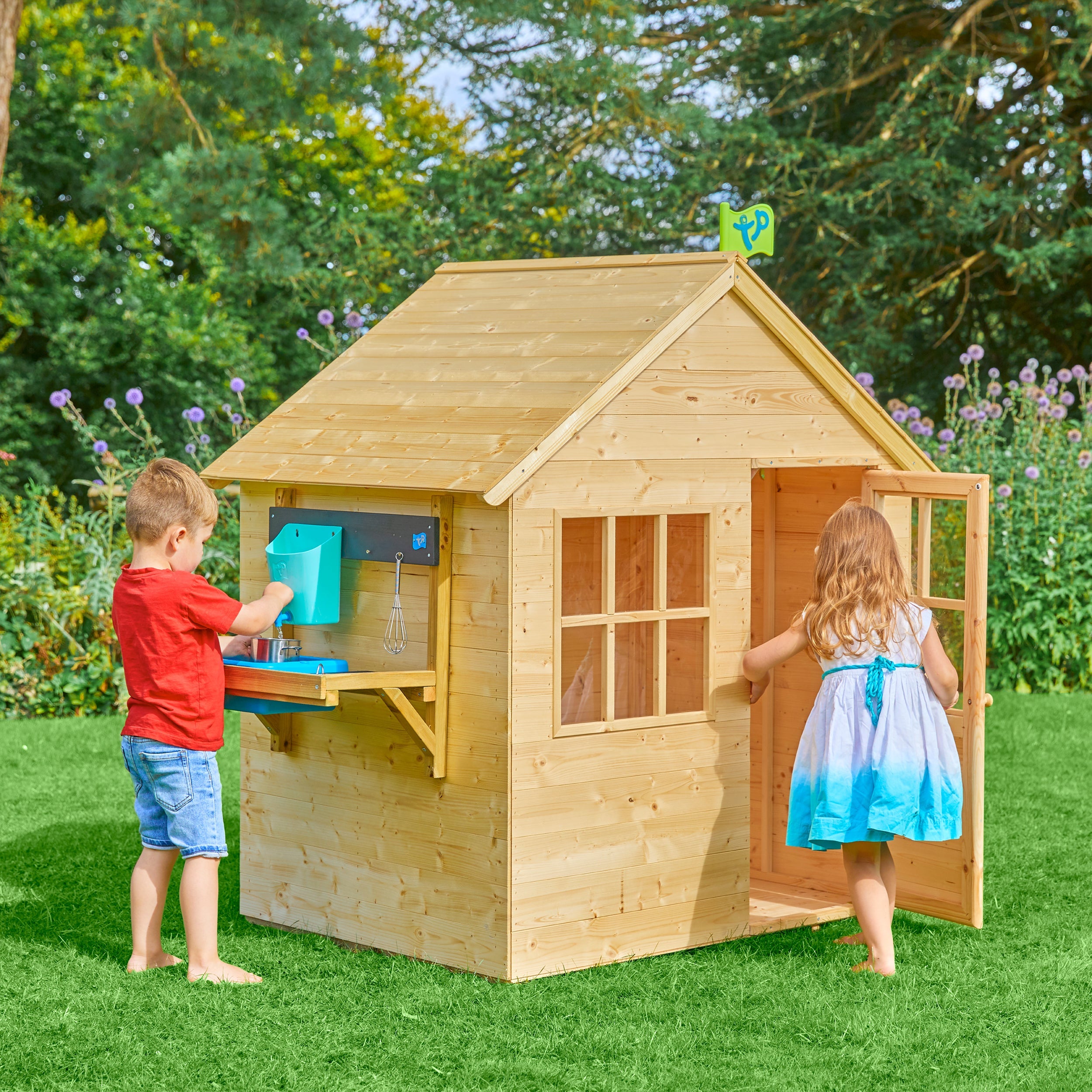  Children playing with wooden playhouse 