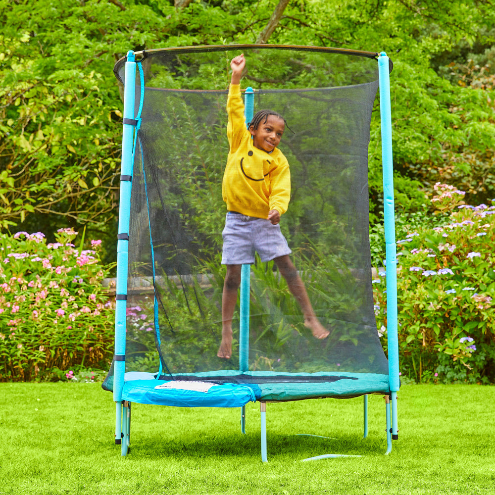 Child playing on outdoor trampoline