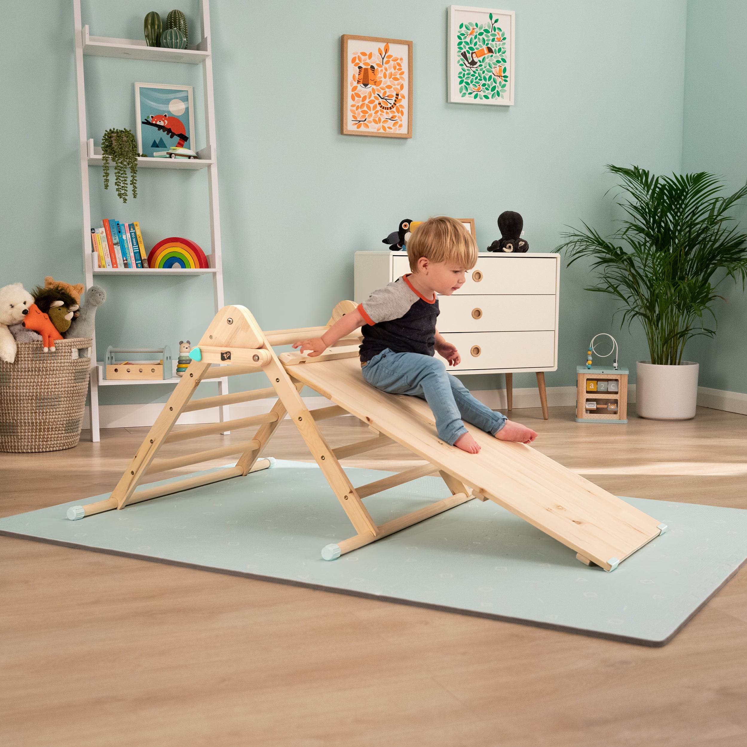  Child playing on wooden climbing triangle 