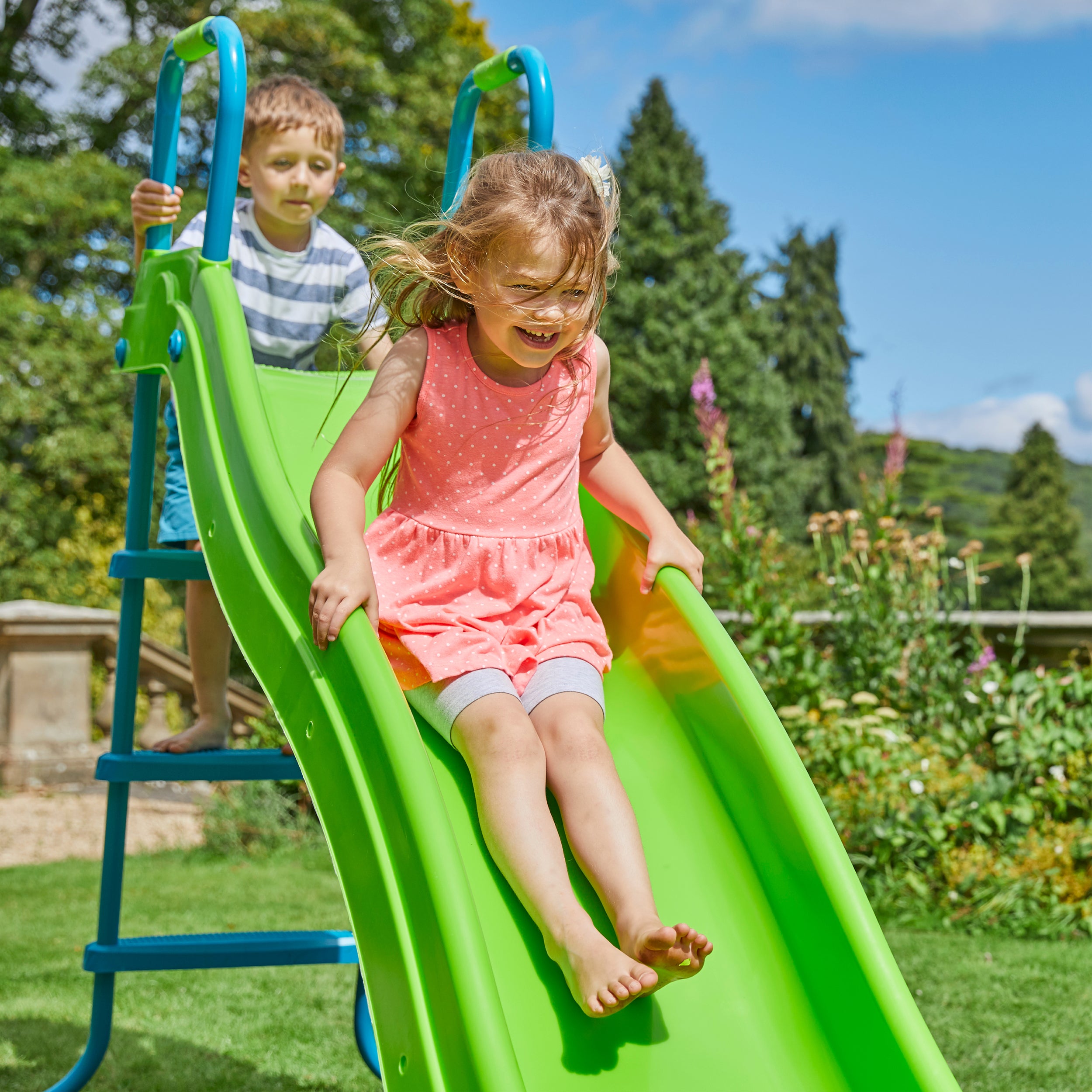  Children playing on garden slide 